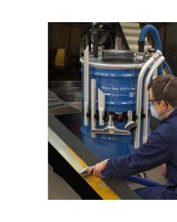 A technician uses a Heavy Duty HEPA Vac to perform scheduled maintenance on a pulverizer.