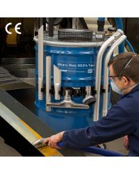 A technician uses a Heavy Duty HEPA Vac to perform scheduled maintenance on a pulverizer.