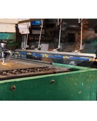 This Long Super Air Knife is blowing off debris created as a laser cutter works on a large metal sheet.