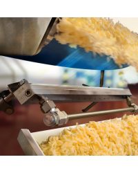 A stainless steel Super Air Knife with Plumbing Kit drying cheese during a shredding operation.